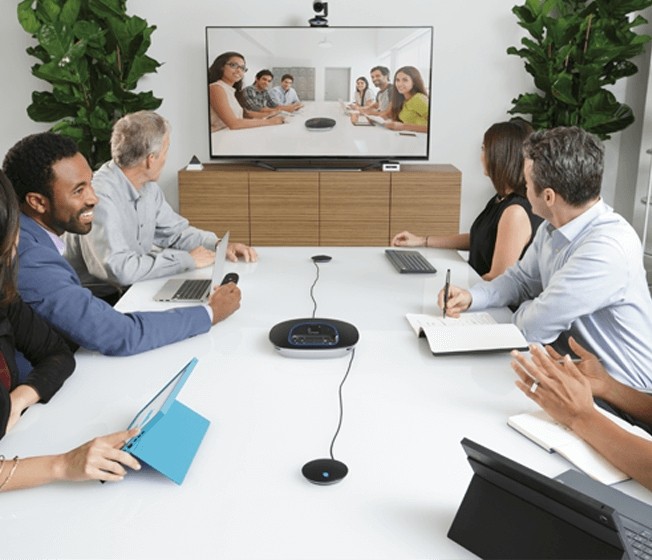 Group using Logitech video conference equipment to host and attend a meeting